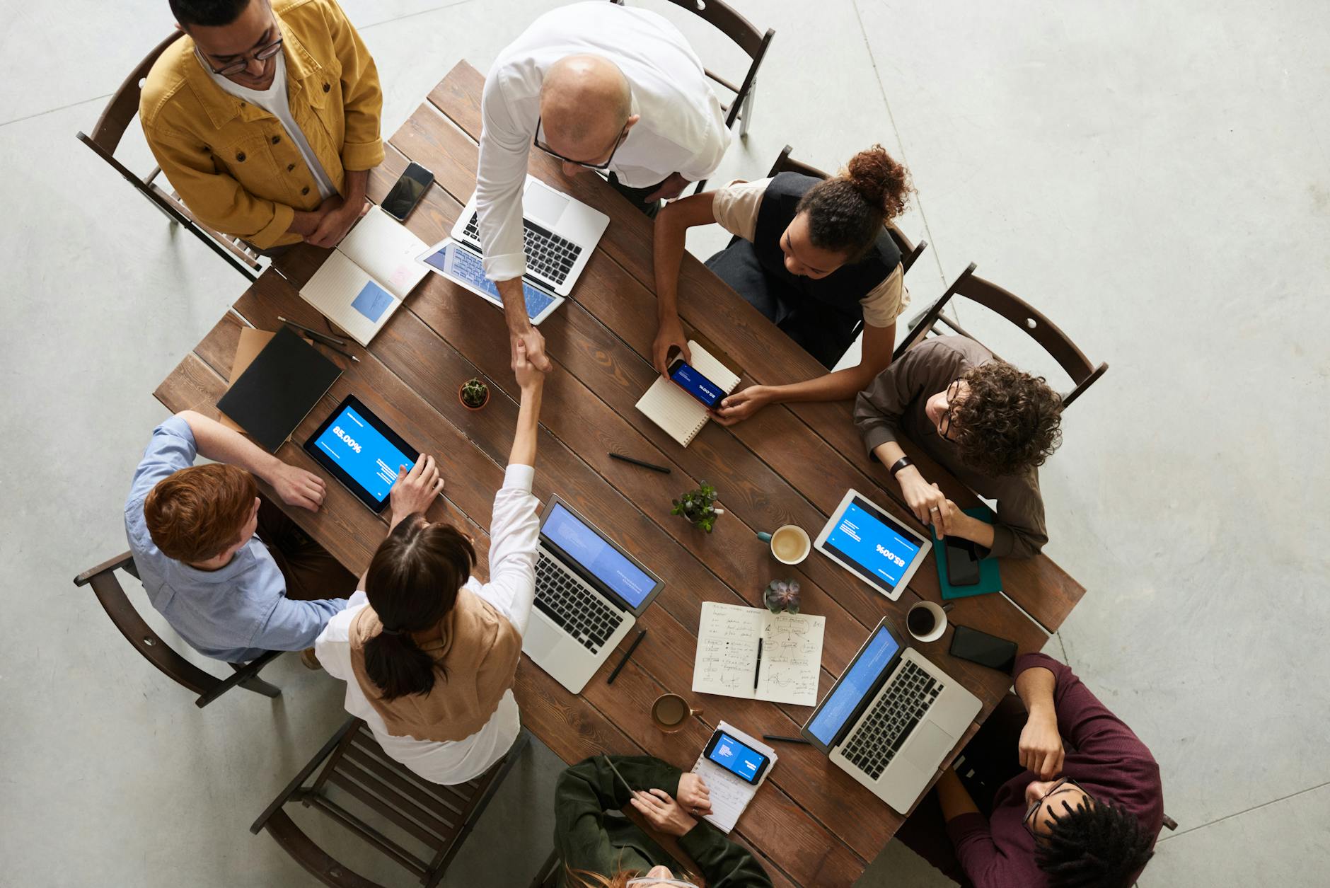 A group of people with a table full of technology in front of them. Showing that technology is everywhere.